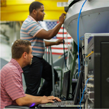 Image of two men working in AvMC's NavLab